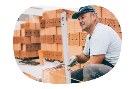 Masonry contractor setting a level at a worksite.