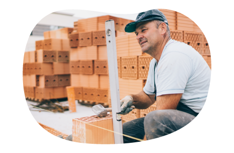 Masonry contractor setting a level at a worksite. Masonry contractor setting a level at a worksite.