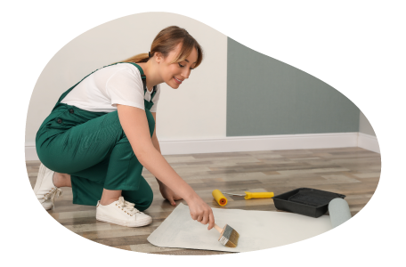 A paperhanging contractor applies adhesive to the back of wallpaper. A paperhanging contractor applies adhesive to the back of wallpaper.