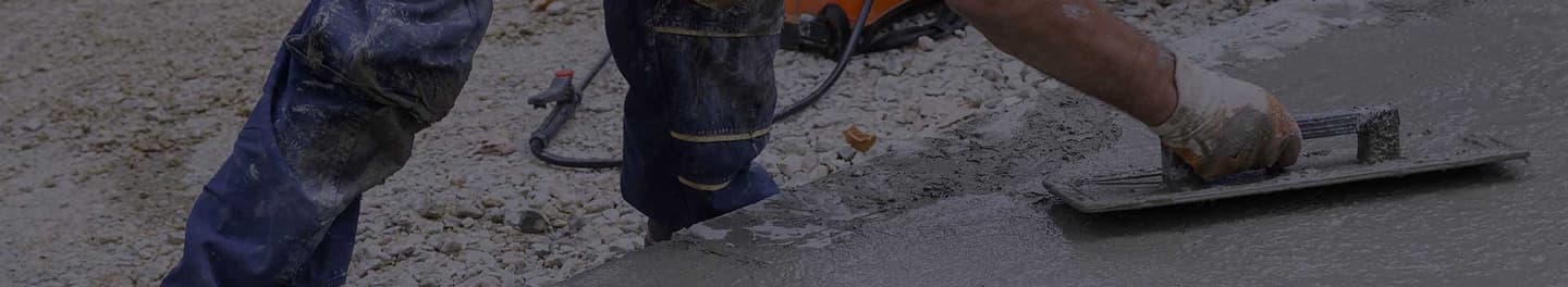 Paving contractor smoothing wet concrete Paving contractor smoothing wet concrete