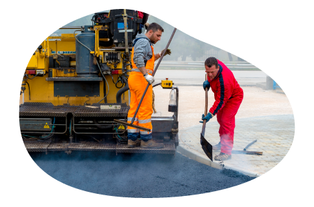 Contractors paving the ground at a worksite. Contractors paving the ground at a worksite.