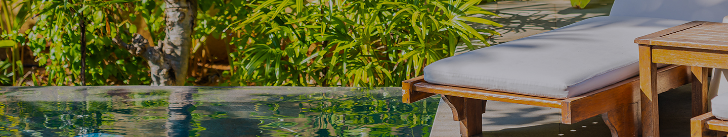 A newly constructed pool with lounge chairs and landscaping.