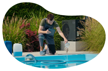 A pool and spa contractor adds chemicals to a new swimming pool.