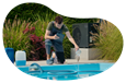 A pool and spa contractor adds chemicals to a new swimming pool.
