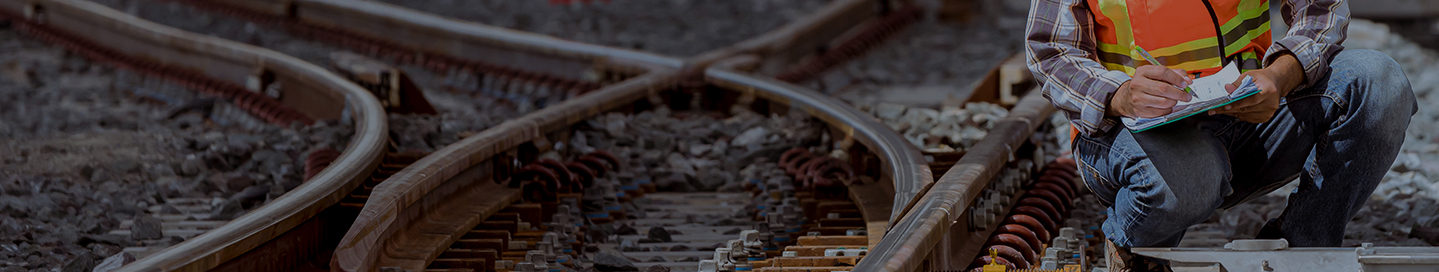 A railroad contractor inspects a switch.