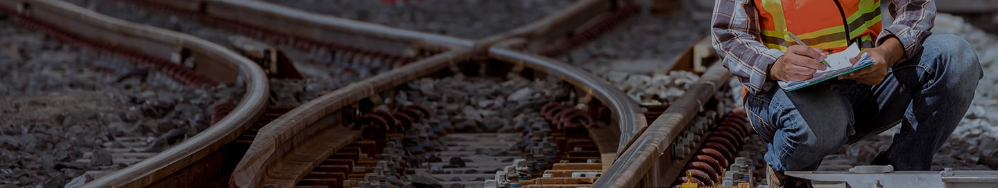 A railroad contractor inspects a switch. A railroad contractor inspects a switch.