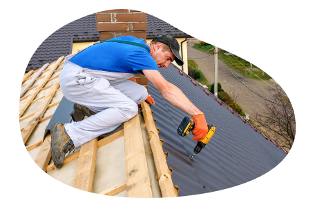 Roofing contractor applying tile to the roof of a house.