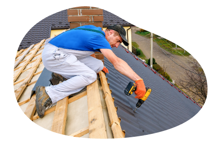 Roofing contractor applying tile to the roof of a house.