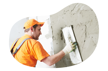 Contractor smoothing plaster onto a building.