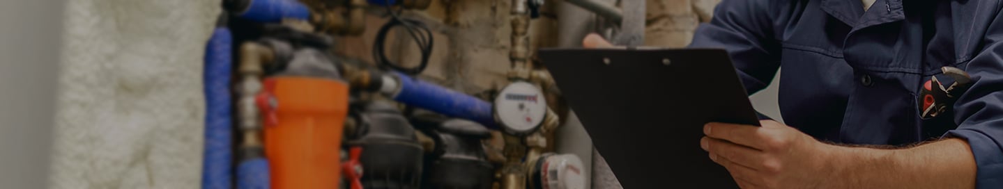 A technician inspects a building's utility system. A technician inspects a building's utility system.