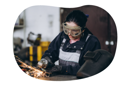 Professional welding together a piece of metal equipment.