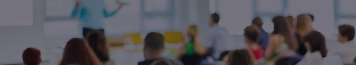 Educator in front of a classroom.