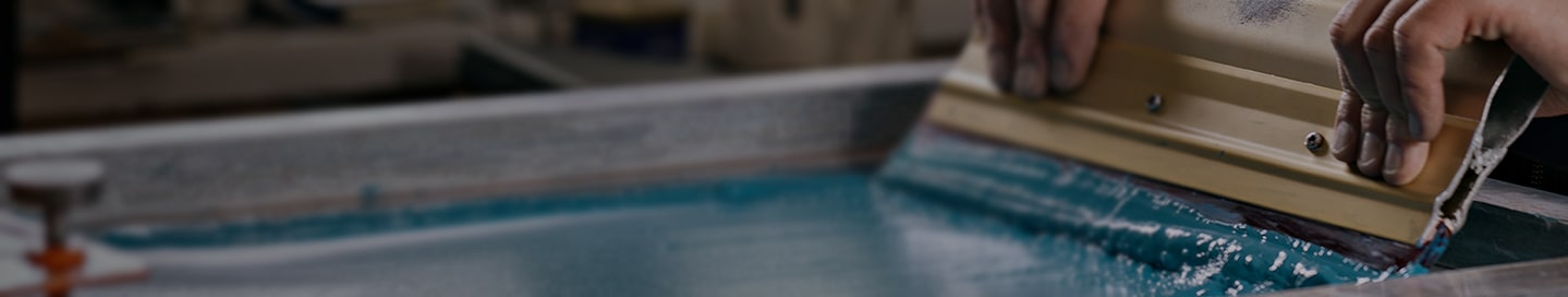 Screen printer with blue ink.