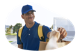 A Grubhub driver hands a meal to a customer.