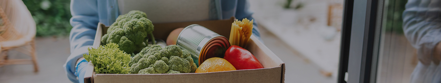 An Instacart shopper with a delivery of produce and other food for a customer.