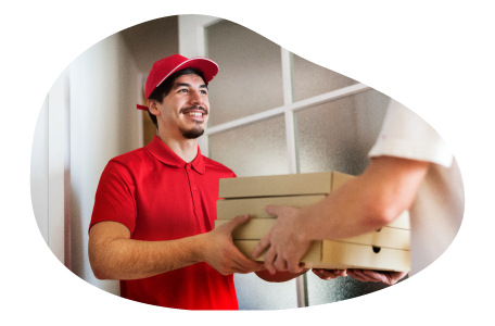 A delivery driver hands several boxes of pizza to a customer. A delivery driver hands several boxes of pizza to a customer.