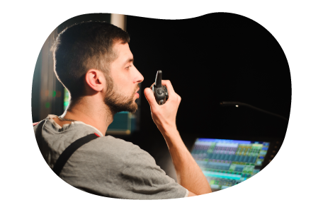 An audio-visual (AV) technician works at a production console.