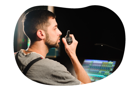 An audio-visual (AV) technician works at a production console. An audio-visual (AV) technician works at a production console.