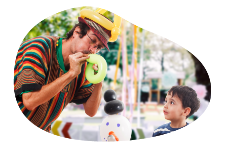 A balloon artist performs for a child.