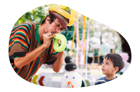 A balloon artist performs for a child. A balloon artist performs for a child.
