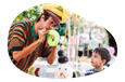 A balloon artist performs for a child.