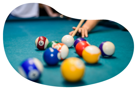 A player takes a shot in a billiard hall. A player takes a shot in a billiard hall.