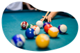 A player takes a shot in a billiard hall.