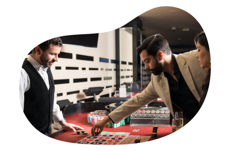 Players bet on a roulette wheel at a casino. Players bet on a roulette wheel at a casino.