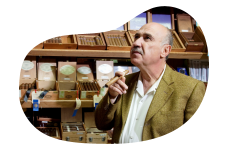 A patron smokes a cigar in a cigar lounge.