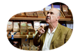 A patron smokes a cigar in a cigar lounge.