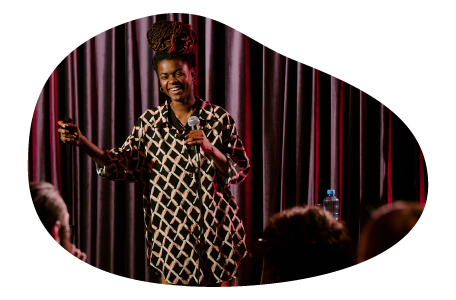 A stand-up comedian performs at a comedy club. A stand-up comedian performs at a comedy club.
