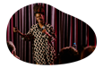 A stand-up comedian performs at a comedy club.