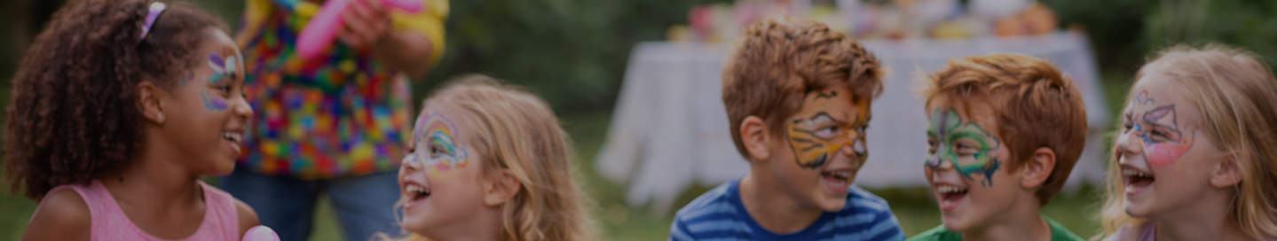 A group of children with colorful designs from a face painter.