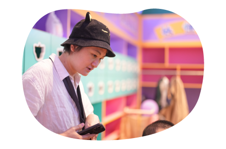 An employee at an indoor playground supervises children.