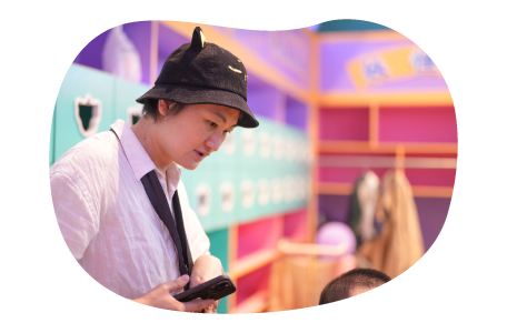 An employee at an indoor playground supervises children. An employee at an indoor playground supervises children.