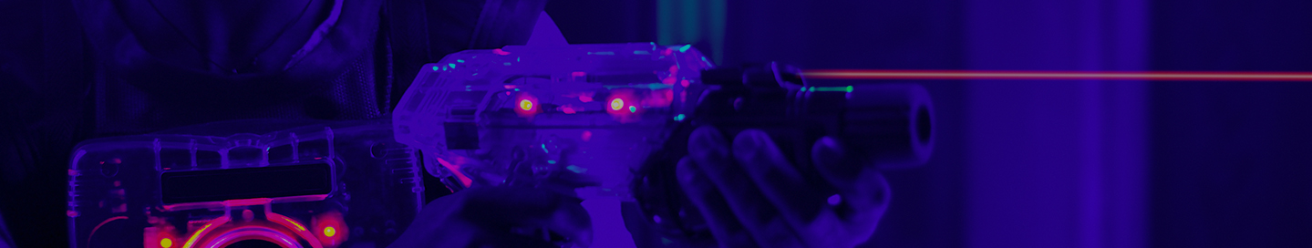 A customer holding a laser tag gun.
