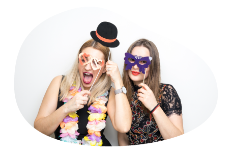 Customers posing with accessories in a photo booth.