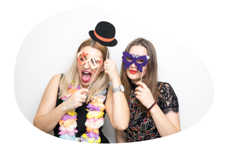 Customers posing with accessories in a photo booth. Customers posing with accessories in a photo booth.