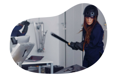 A rage room customer gets ready to strike with a bat.