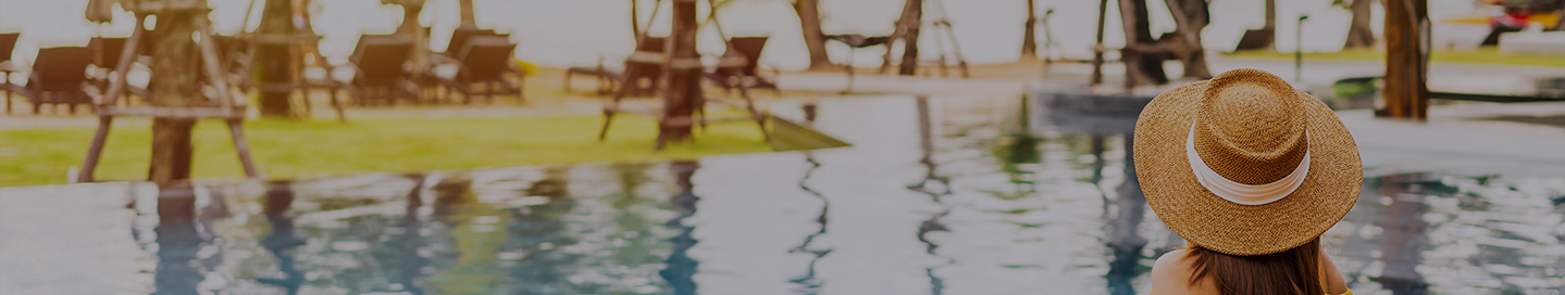 A customer relaxes by a resort's pool.