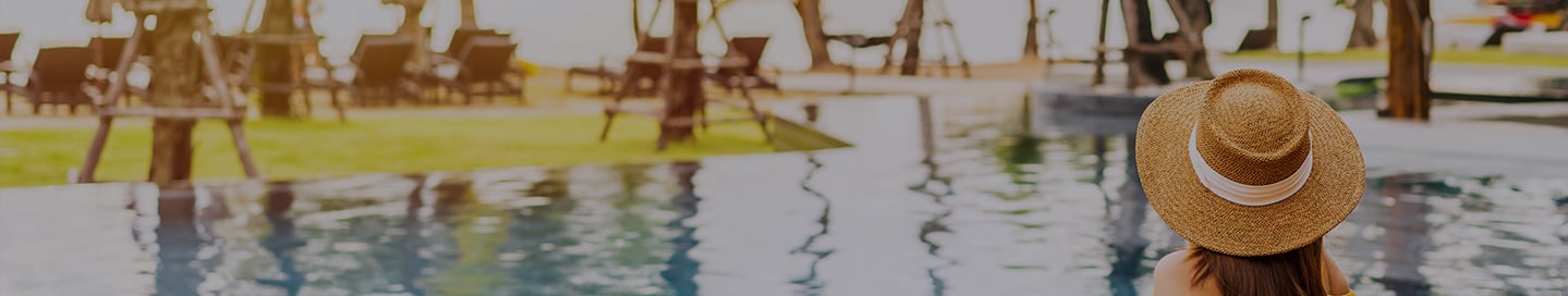 A customer relaxes by a resort's pool. A customer relaxes by a resort's pool.