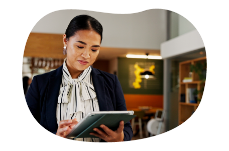 A resort owner works on a tablet in the lobby. A resort owner works on a tablet in the lobby.