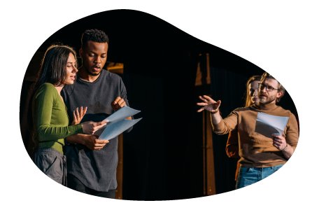 Actors rehearse a theatrical production on a stage.