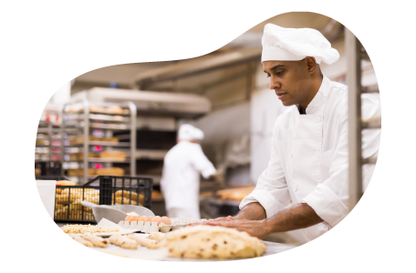 Baker preparing dough in a kitchen. Baker preparing dough in a kitchen.