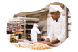 Baker preparing dough in a kitchen.