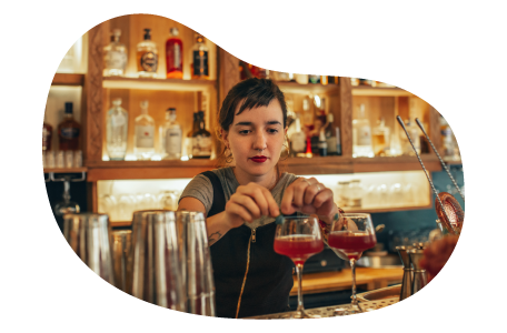Bartender preparing two drinks.