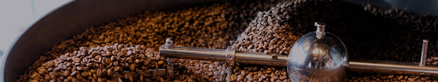 Coffee beans inside a coffee roaster. Coffee beans inside a coffee roaster.