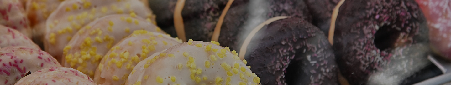 Rows of a variety of donuts at a donut shop