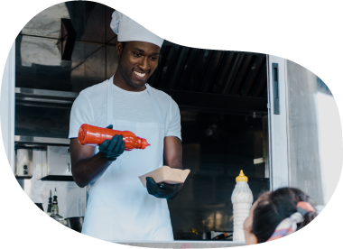 Food truck cook putting together an order.