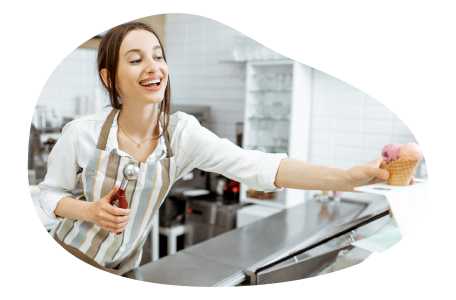 Ice cream shop employee handing an order to a customer. Ice cream shop employee handing an order to a customer.